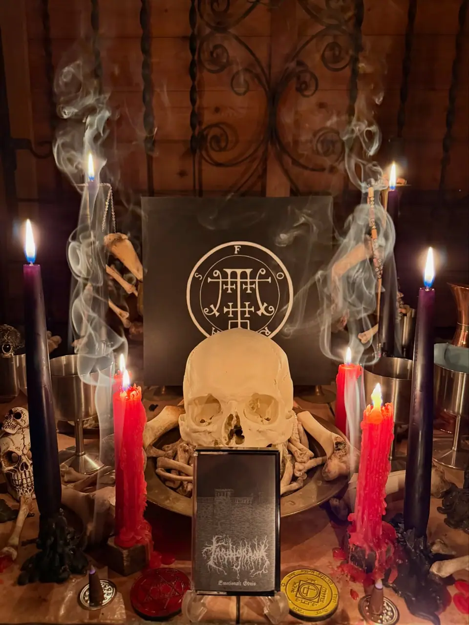 Foras's altar: a skull on a plate of bones before the seal of Foras, between purple and red candles, with a release standing in front